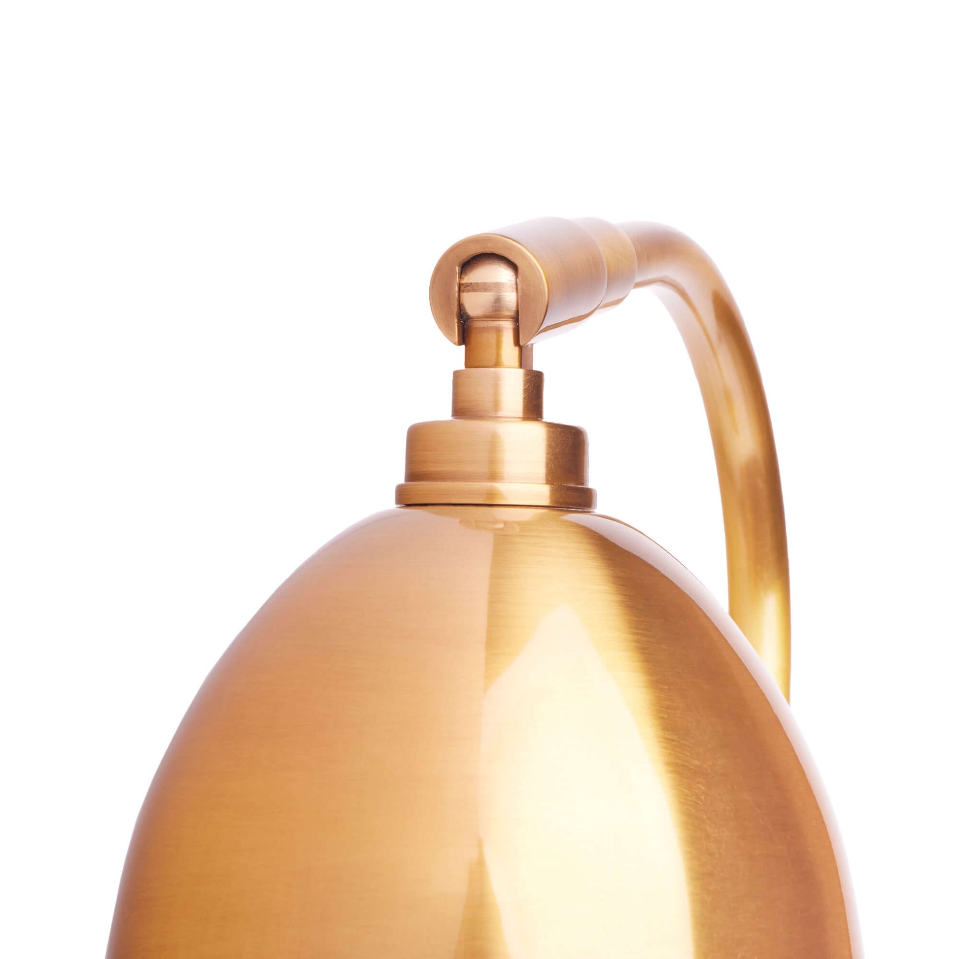 DET,alt:Close-up of a brass-coloured, dome-shaped metallic lamp with a curved arm and a glossy finish against a white background.